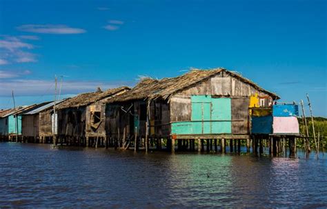 an old wooden house on stilts in the water