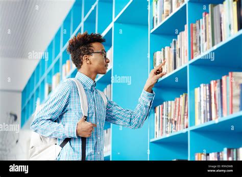 Guy in college library Stock Photo - Alamy