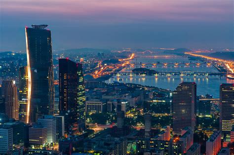 Seoul Skyline at Night - The skyscrapers of Seoul light up as evening ...