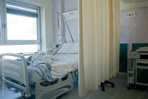 view of hospital room, electronic bed with sheets for a patient ...