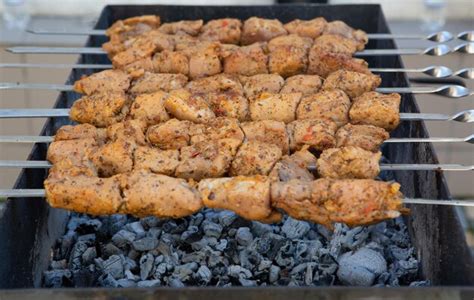 Premium Photo | Shish kebab is prepared on a charcoal grill