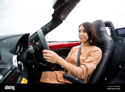 Woman driving convertible car Stock Photo - Alamy