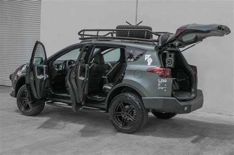 an suv with its doors open and luggage strapped to the back