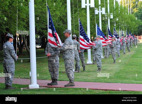 Airmen lower the U.S. flag during the Flag Day ceremony at Offutt Air ...