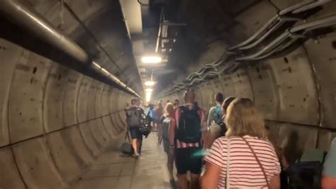 Passengers walk along Eurotunnel after train breaks down inside : r/europe