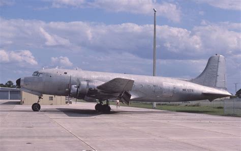 an airplane is parked on the tarmac in front of a fenced off area