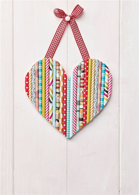 a paper heart hanging on a white door