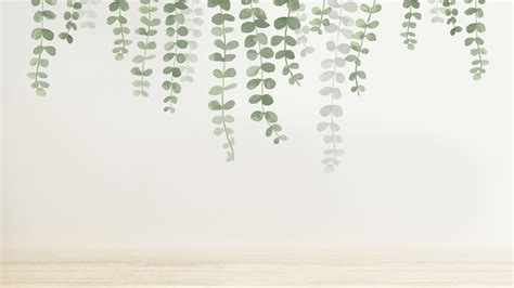 green leaves are hanging from the ceiling in front of a white wall and ...