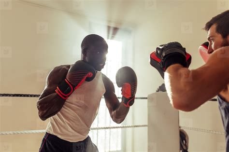 Fighter training with a sparring partner in a boxing ring stock photo ...