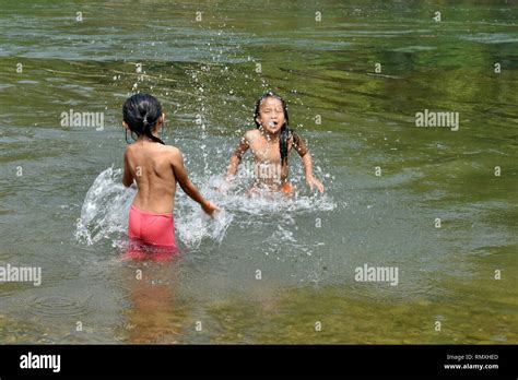 Lao Children playing in the water, Next to Van Vieng, Laos Stock Photo ...