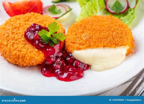 Breaded and Baked Camembert with Cranberry Sauce on Wooden Tabel ...