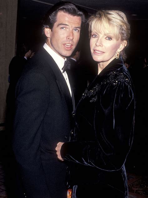 Pierce Brosnan can't keep his hands off wife of 15 years as they cosy ...