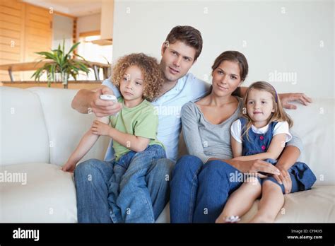 Family watching TV together Stock Photo - Alamy