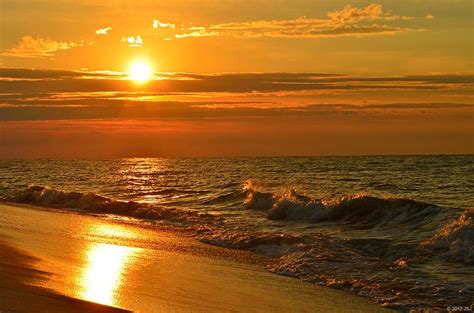 Golden Sunrise Colors With Waves And Horizon Clouds On Navarre Beach ...