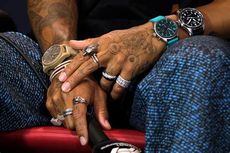 What do Lewis Hamilton's hand tattoos mean?