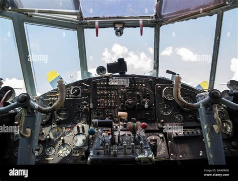 Vintage airplane cockpit interior with blue sky and white clouds in ...