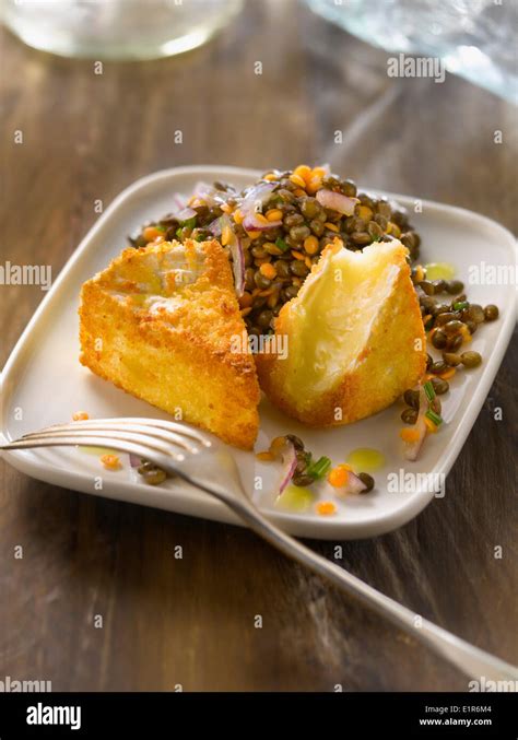 Lentil salad and fried breaded Camembert Stock Photo - Alamy