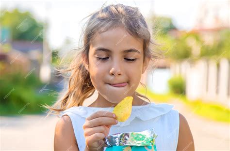 Premium Photo | The child is eating chips. selective focus. kid.