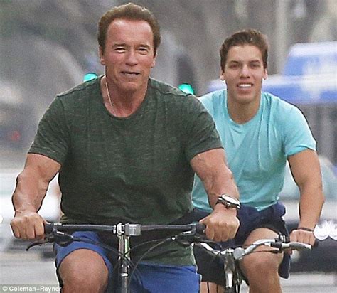 Arnold Schwarzenegger cycles with look-alike lovechild Joseph Baena ...