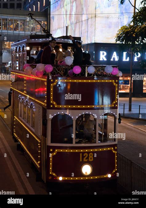 Vertical view of a traditional old tram at night in Hong Kong, China ...