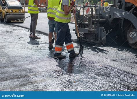 Workers Operating Asphalt Paver Machine during Road Construction and ...