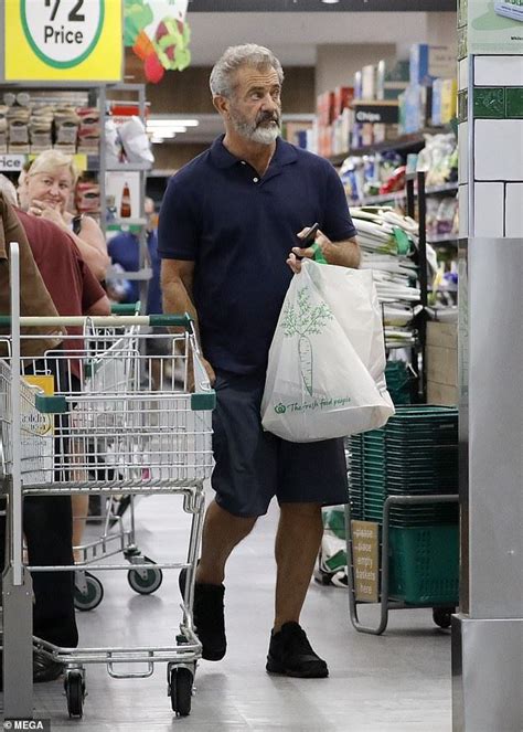 an older man is shopping in a grocery store