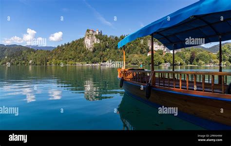 A picture of one of Lake Bled's gondolas, named "pletna", overlooking ...