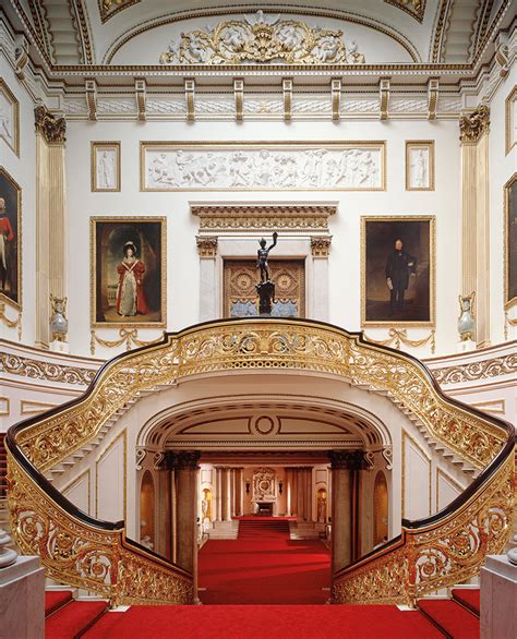 an ornately decorated hallway with red carpet and gold railings ...