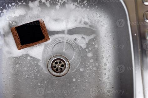 cleaning the kitchen sink 5692553 Stock Photo at Vecteezy