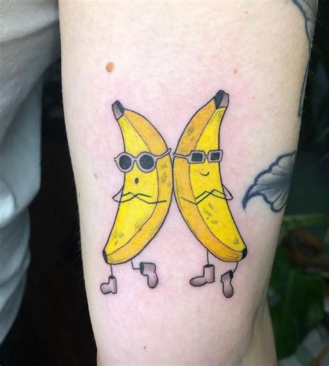 two yellow bananas with glasses on their faces