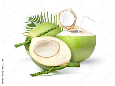 Young green coconut with coconut juice in half fruit and palm leaf ...