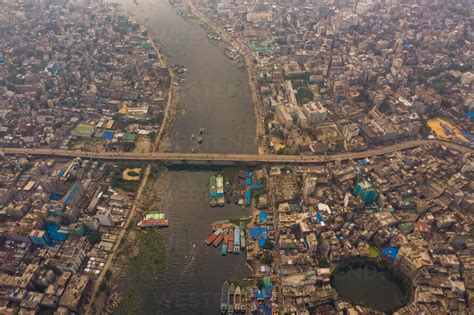 Aerial view of Dhaka skyline city centre along Buriganga river with Gol ...