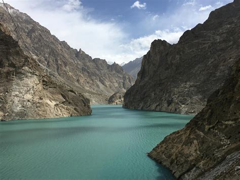 River Between Rocky Mountains Under Blue Sky · Free Stock Photo