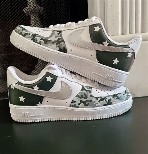 Custom sneakers with painted silver swooshes, grey and white stars, and ...