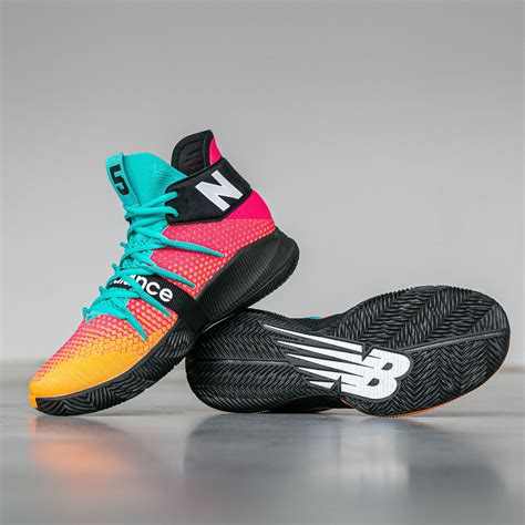 the new balance basketball shoe is shown in pink, yellow and blue ...