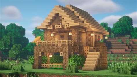 a house made out of wood in the middle of a field with trees and bushes