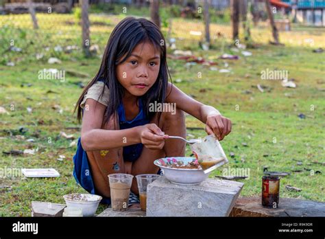 Thakhek, Laos - April 19 2018: Local chil playing to make a meal with ...