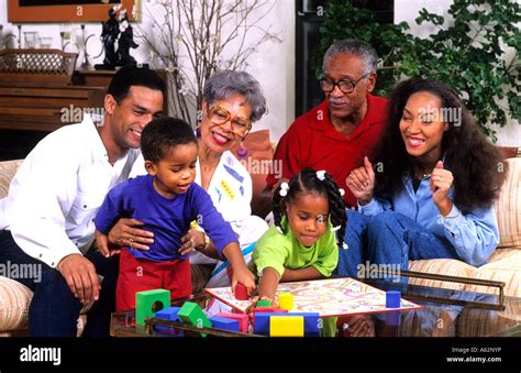 Three generation black african american family playing board games at ...