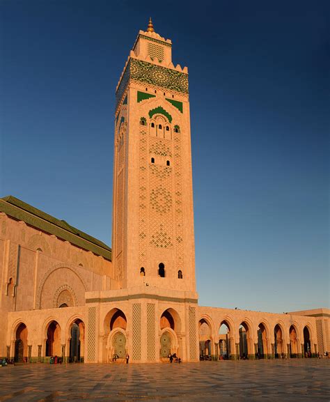 Golden Hassan II Mosque and minaret with blue sky at sunset Photograph ...