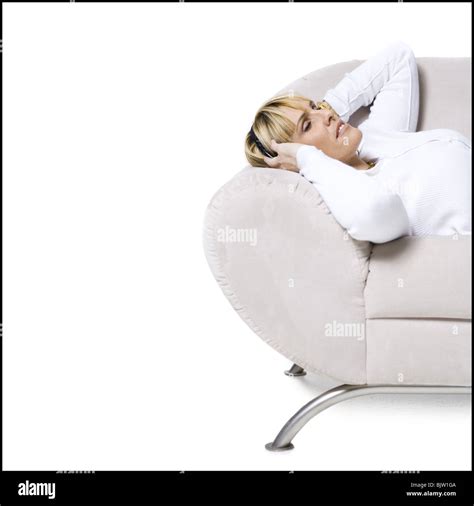 Woman smiling resting on couch Stock Photo - Alamy