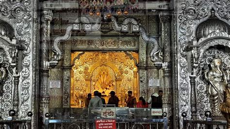 people standing in front of an ornately decorated building with gold ...