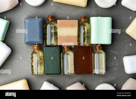 Bottles of essential oil and soap bars on gray background Stock Photo ...