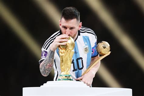 Lionel Messi Kisses His Trophy While Celebrating Win at FIFA World Cup ...