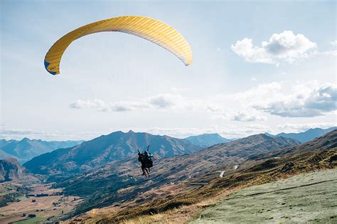 Royalty-Free photo: Person on yellow parachute flying during daytime ...