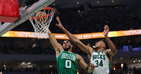 WATCH: Jayson Tatum sends in a one-handed dunk over Giannis - On3