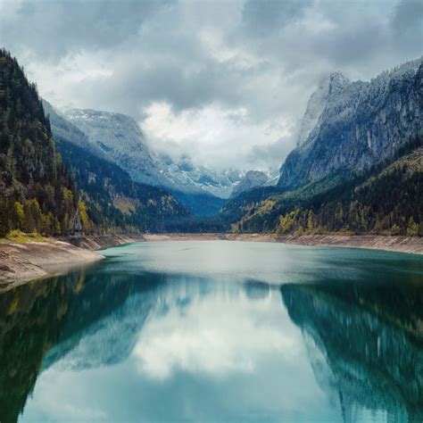 Alpine lake with dramatic sky and mountains | Alpine lake, Lakes ...