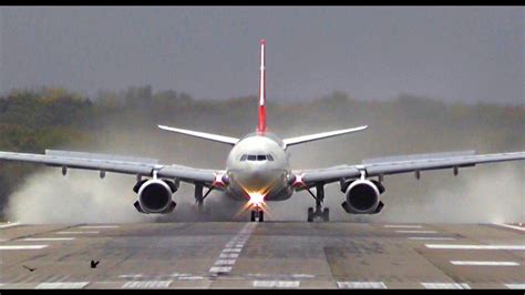 Turkish Airline A330 - Awesome reverse thrust after wet & windy landing ...