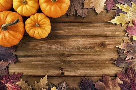 Pumpkins with Fall Leaves Over Wooden Background. Top View Stock Photo ...