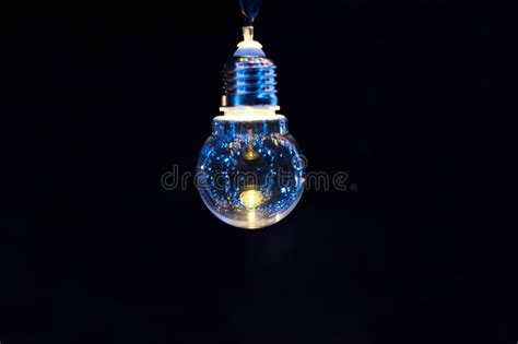 Glowing Decorative Light Bulb on a Dark Background Stock Image - Image ...