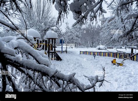 Snowy playground in winter. Empty urban park during snowfall. Scenery ...